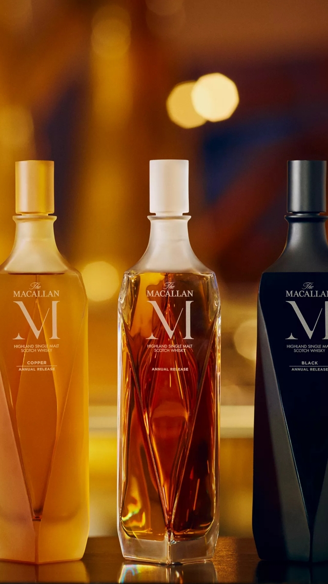 The Macallan M Copper 2023 whisky bottle trio in lively environment