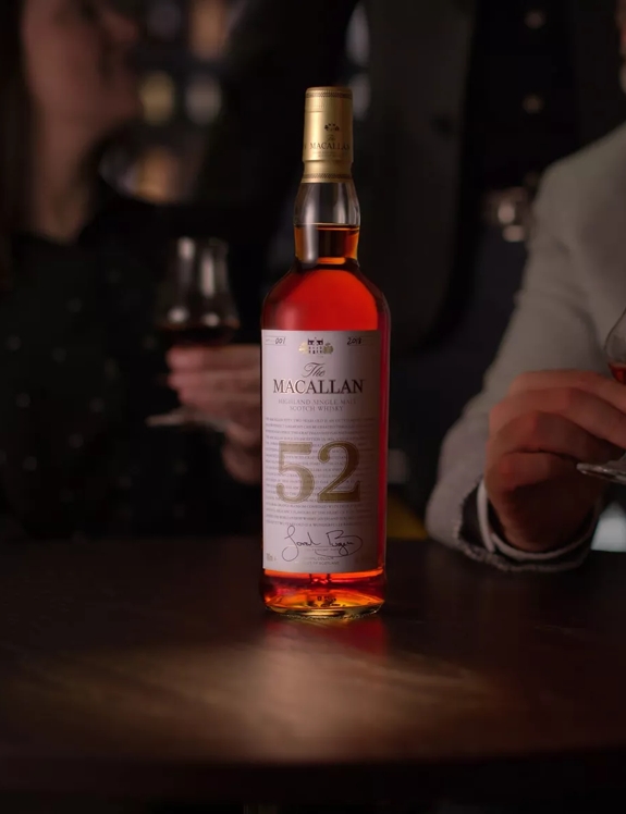 The Macallan 52 year old whisky bottle on table in bar