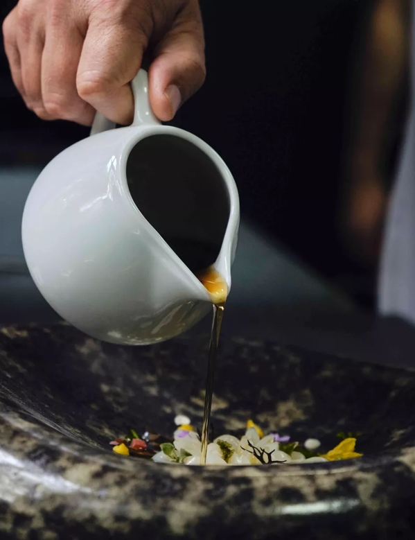 Pouring Sauce onto Plate