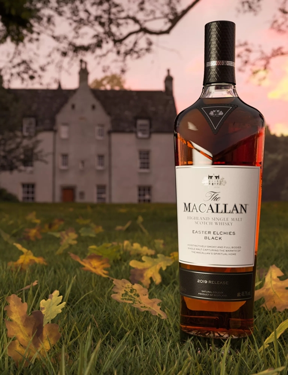 easter elchies black whisky bottle in front of Macallan estate