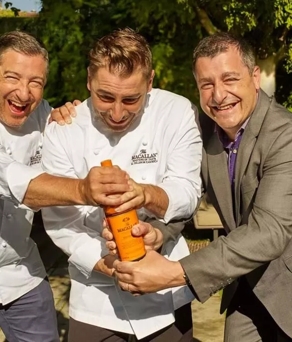 the roca brothers holding whisky bottle