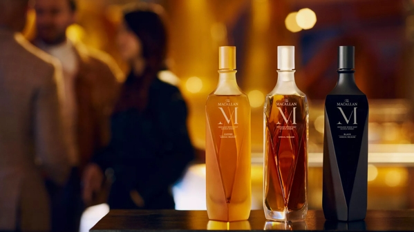 The Macallan M Copper 2023 whisky bottle trio in lively environment
