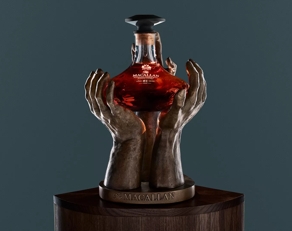 The Macallan The Reach Sculpture and bottle on blue background