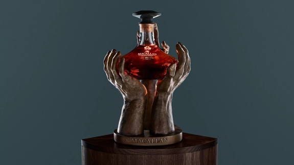 The Macallan The Reach Sculpture and bottle on blue background