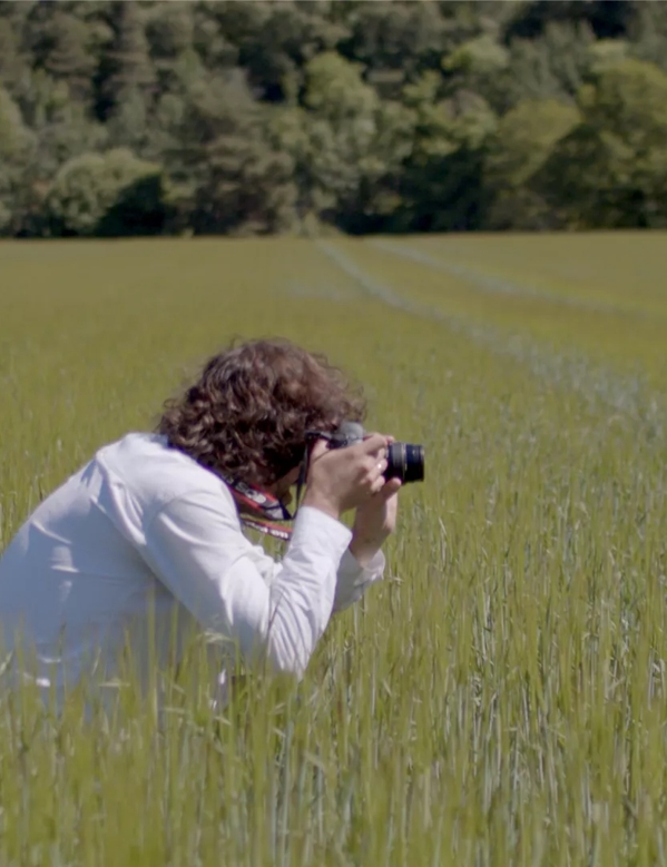 Erik Madigan Heck in field taking photo