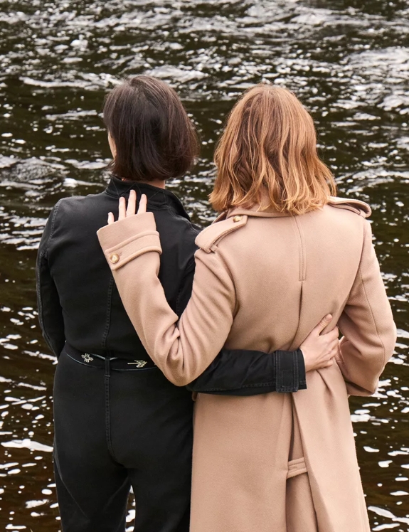 stella and mary mccartney standing facing the river spey