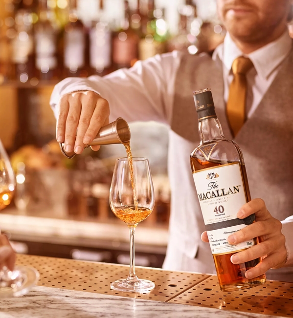 the macallan sherry oak 40 years old 2017 release whisky being poured into glass