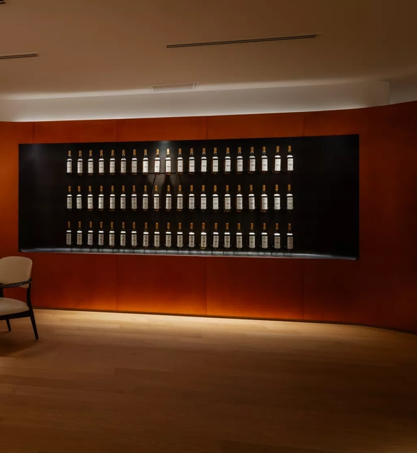 The Macallan House Hong Kong seating area and bottles on wall 