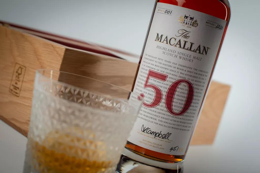 The Macallan red collection 50 year old whisky bottle and glass close up