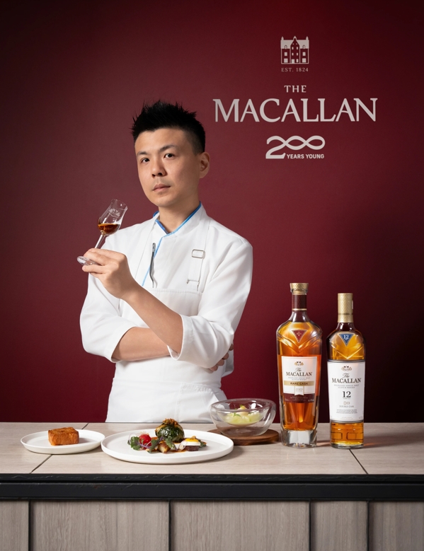 The Macallan Taiwan Event guest with food and bottles, holding a dram