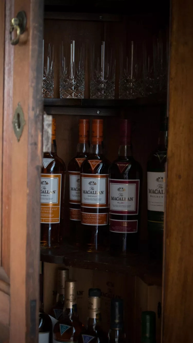 the macallan whisky bottles in cabinet