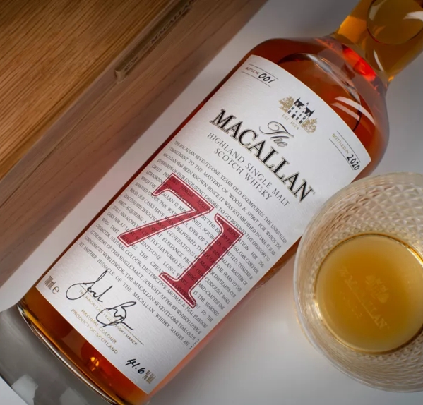 The Macallan Red Collection 71 year old whisky bottle and glass angled