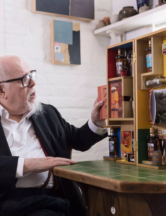 Sir Peter Blake in studio with designs