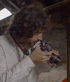 Erik Madigan Heck taking pictures of oak barrels 