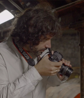 Erik Madigan Heck taking pictures of oak barrels 
