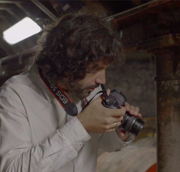 Erik Madigan Heck taking pictures of oak barrels 