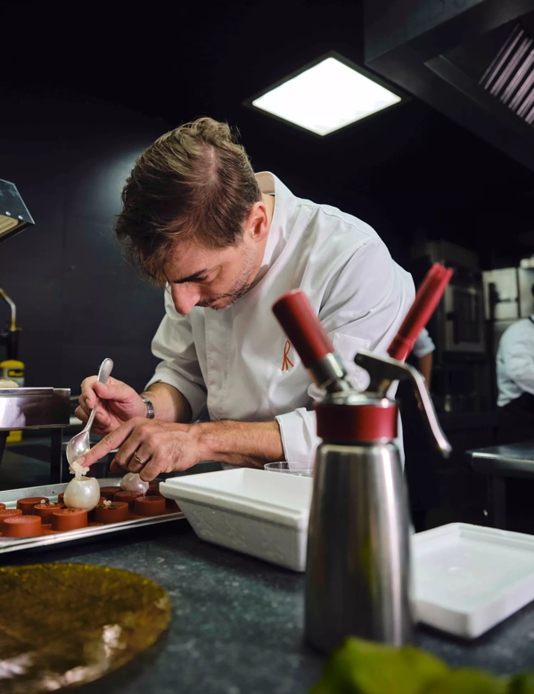 Distil Your World London Jordi adding details on plate