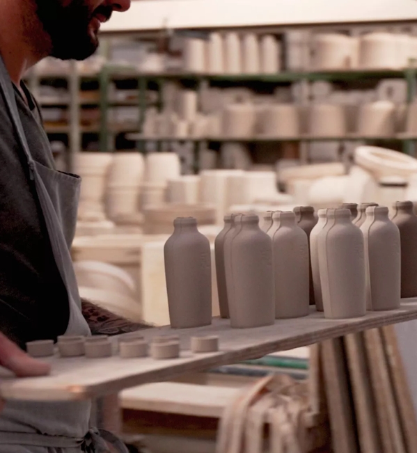 man carrying ceramics