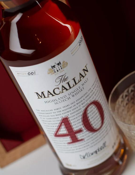 The Macallan Red Collection 40 year old whisky bottle and glass angled shot