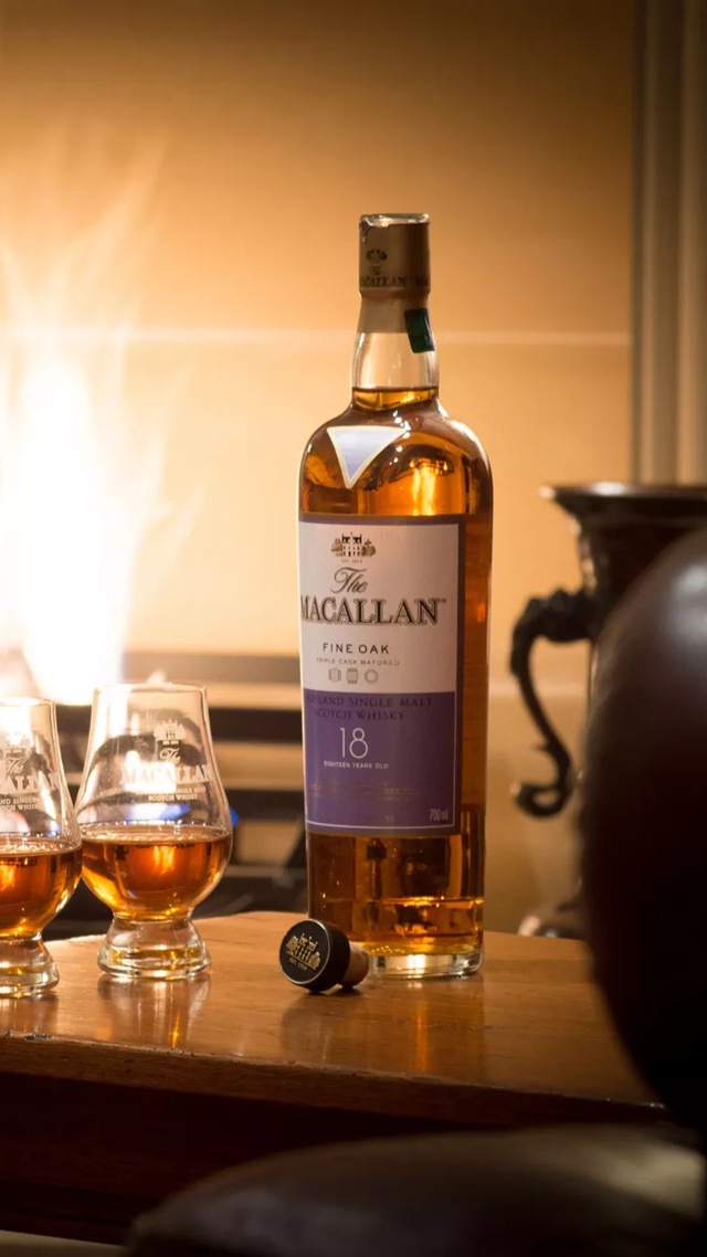 the macallan whisky bottle and drams by fireplace
