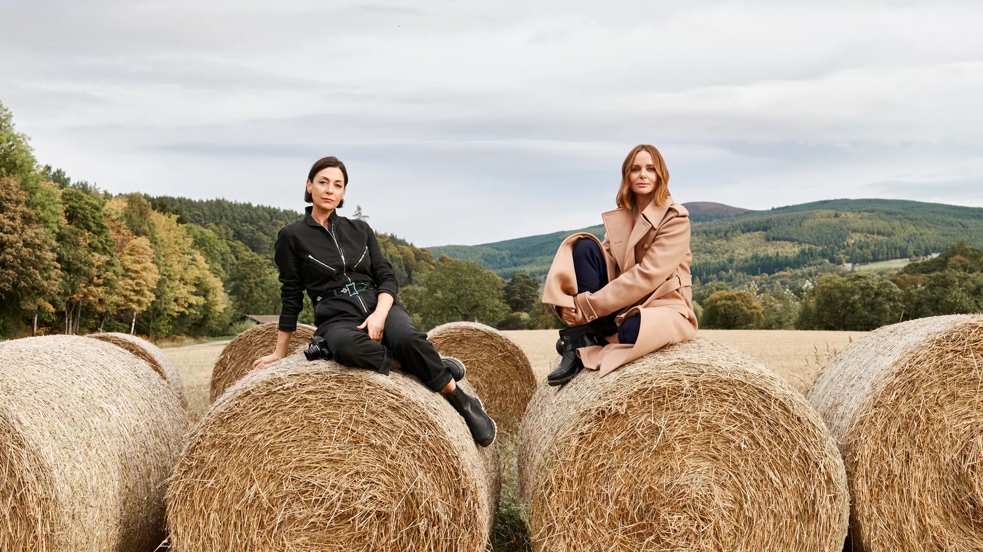 stella and mary mccartney sitting on hay bales