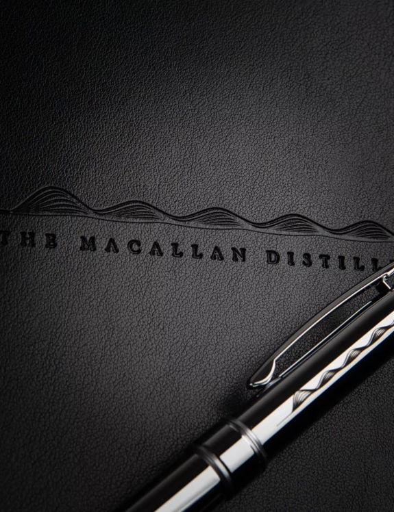 The Macallan Notebook and Pen Close up of The Macallan Logo Printed