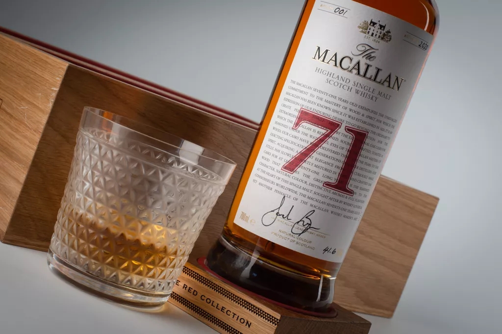 The Macallan Red Collection 71 year old whisky bottle and glass angled shot