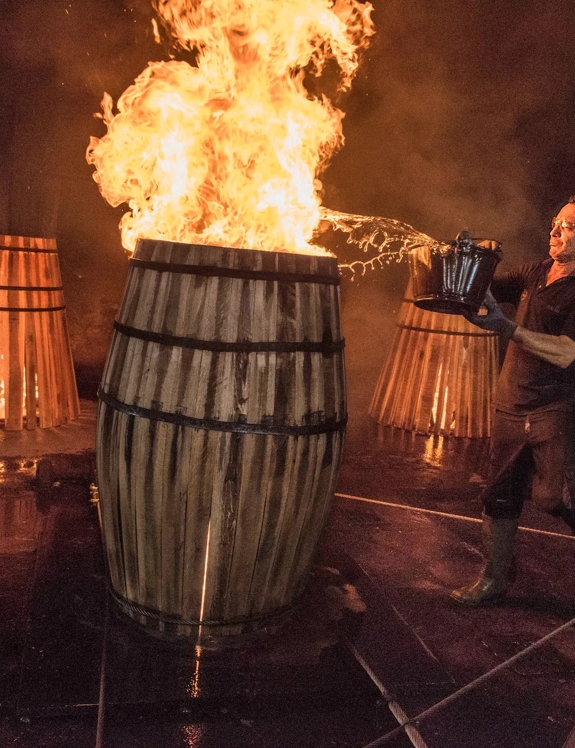 the macallan whisky casks production man with fire