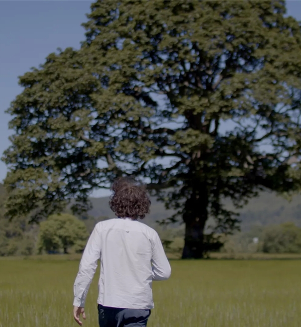 Erik Madigan Heck walking in field