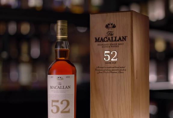 the macallan 52 years old 2018 release whisky bottle and box in bar