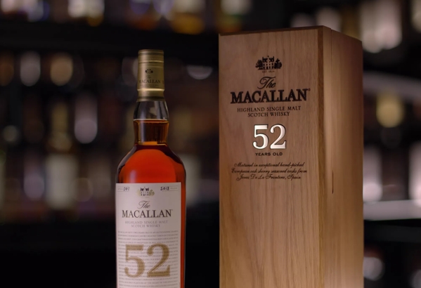 the macallan 52 years old 2018 release whisky bottle and box in bar