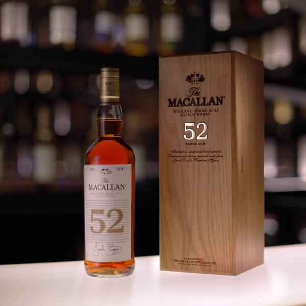 the macallan 52 years old 2018 release whisky bottle and box in bar