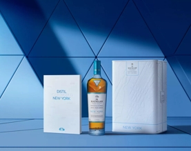 The Macallan Distil Your World New York Box, Bottle and Book on Blue Backdrop