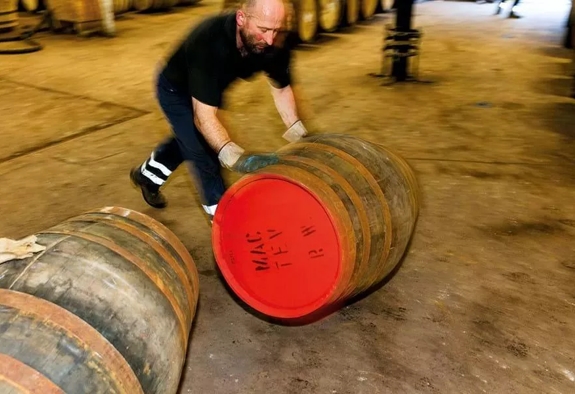 Martin Parr Images for The Distillery and the Magnum Collection Man Rolling cask