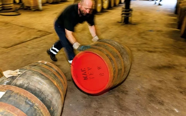 Martin Parr Images for The Distillery and the Magnum Collection Man Rolling cask