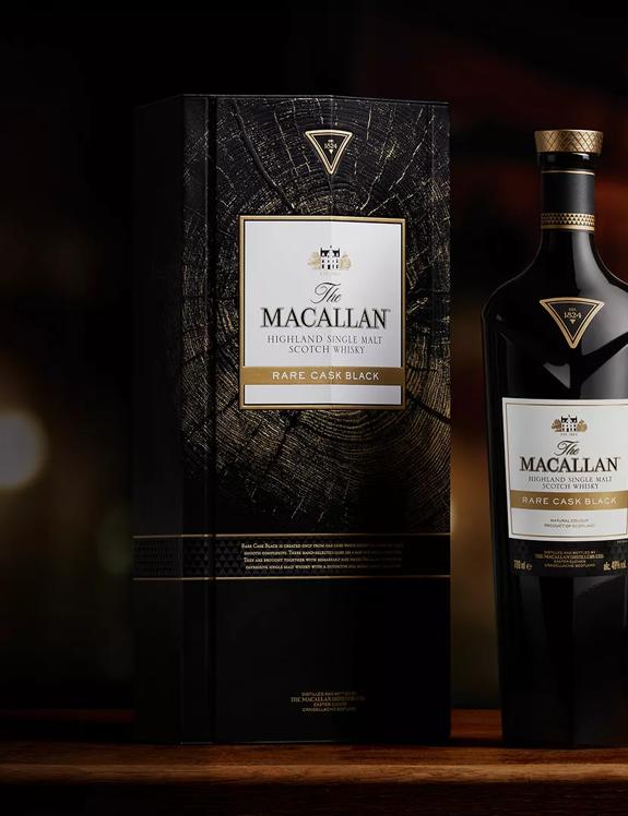 The Macallan Rare Cask Black whisky bottle and closed box on dark moody background