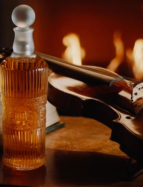 Tales of The Macallan Bottle of Whisky and Violin by Fireplace
